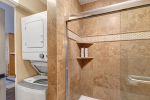 Resort Plaza 5024s shared bathroom with a stackable washer and dryer.