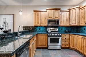 Your fully equipped kitchen features rich wood cabinetry, granite countertops, and modern stainless steel appliances to make meal preparation a joy.