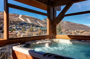Soak in bubbling warmth while gazing at stunning mountain ski slopes and valley views from your private hot tub retreat.