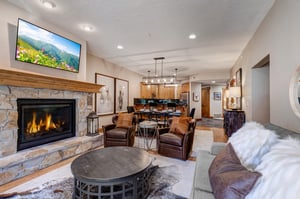 Relax in your spacious living room with a cozy stone fireplace, comfortable leather seating, and modern entertainment center  perfect for unwinding after a day of adventure.