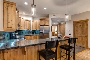 Your fully equipped kitchen features beautiful wood cabinetry, granite countertops, and modern stainless steel appliances  perfect for preparing meals during your stay.