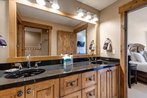 Youll love the spacious double vanity with beautiful wood cabinetry and granite countertops  perfect for getting ready with plenty of storage space.