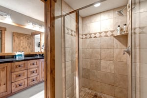 Step into your private spalike retreat with a spacious walkin shower featuring elegant stone tilework and a convenient builtin shelf for your essentials.