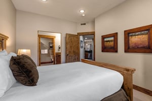 Rest comfortably in your cozy bedroom featuring rustic wood accents, crisp white linens, and warm lighting that creates the perfect mountain retreat atmosphere.