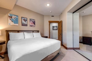 Sink into your comfortable king bed after a day exploring the slopes  crisp linens and skithemed artwork create the perfect mountain retreat atmosphere.