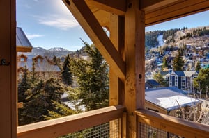 Take in stunning mountain vistas and charming village views from your private wooden balcony, where warm timber beams frame the perfect Alpine retreat setting.