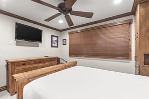 Drift into comfort beneath your ceiling fan, with warm wood furnishings and a flatscreen TV for cozy evenings in.