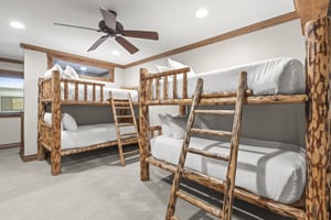 Your group will love this rustic bunk room with handcrafted log beds and fresh linens for a cozy mountain cabin experience.