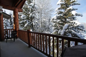 The private patio provides views of the evergreen trees