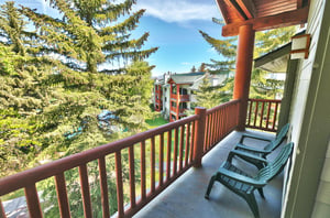 The private patio provides views of the evergreen trees