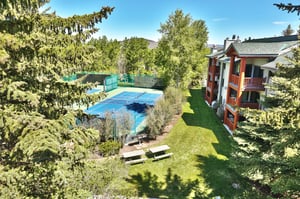 The private patio shows views of the tennis courts in the summer