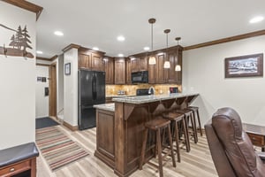 Your fullyequipped kitchen beckons with rich wood cabinetry, granite counters, and a breakfast bar with seating for 4 guests.