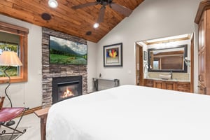 Your cozy retreat features warm wood ceilings, crackling fireplace, and luxurious bedding.