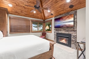 Cozy up in your bedroom sanctuary with soaring wood ceilings, crackling fireplace, and peaceful views.