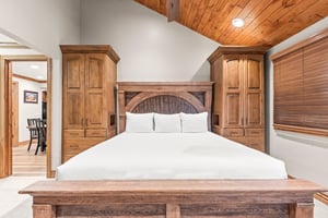 Retreat to your cozy bedroom with handcrafted wood details, crisp linens, and builtin storage.