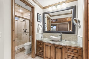 Relax in your spalike bathroom featuring granite countertops, vessel sink, and spacious walkin shower.