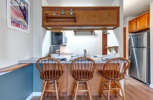 The breakfast bar with seating for three guests.