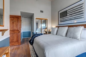 Drift off in this stylish bedroom on a kingsize bed.