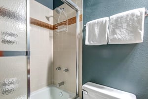 The en suite bathroom with a bathtub and shower combination.