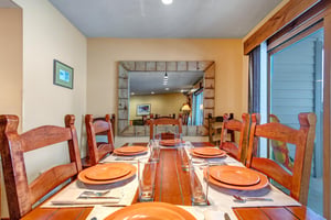 Gather around this inviting wooden dining table with seating for 8 guests.