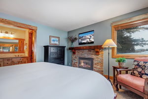 The main suite offers a kingsize bed, fireplace, and en suite bathroom.