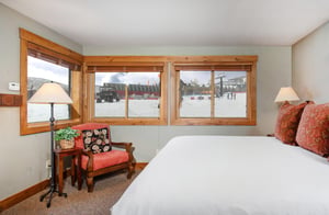 The main suite features large windows overlooking Park City Mountain Resort.