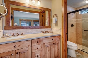 The main suites en suite bathroom offers a double sink vanity.