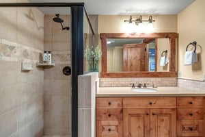 The shared bathroom offers a single sink vanity and walkin shower.