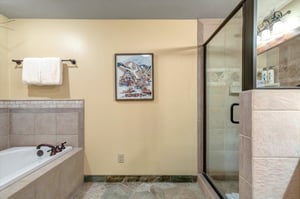 The shared bathroom offers a walkin shower and deep soaker bathtub.