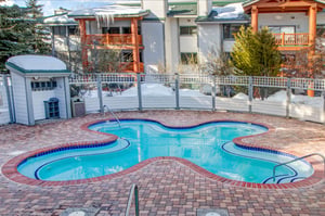 Soak in the heated outdoor pool in the shape of a flower at Snow Flower Condominiums.