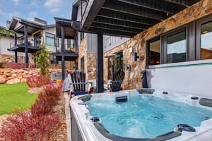 Soak in your private hot tub while taking in mountain views from this stoneclad terrace.