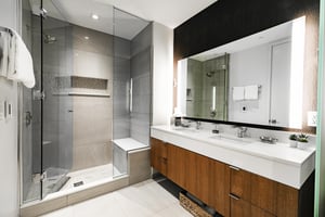 Dual vanity main bathroom, glass panel showere with tiled walls