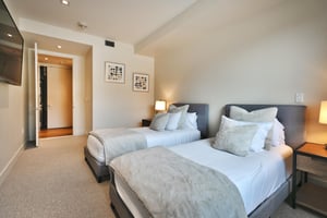 Extra long twin beds in the guest bedroom can be converted to a king bed with advanced notice, wall mounted flat screen TV