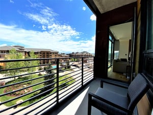 Enjoy the private patio overlooking the resort plaza on a sunny summer day