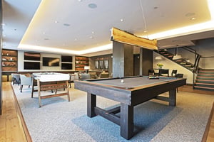 Lift club room complete with wooden billiards table and unique wooden linear pendant chandelier