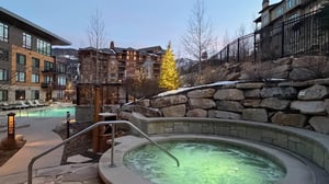 The Lift Condominiums hot tubs, and modern accommodations surrounded by winter scenery.