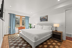 Sink into your plush kingsize bed surrounded by warm hardwood floors, soft natural light, and modern comforts.