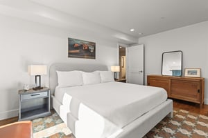 Sink into this serene bedrooms plush bedding after exploring the city. Warm lighting and thoughtful touches create your perfect retreat.
