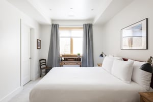 3rd guest bedroom with queen bed and window facing work or study desk