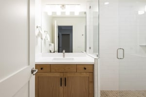 34 bathroom with contemporary wooden cabinets and glass shower enclosure