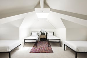 Upstairs bedroom with 4 twin beds and cathedral vaulted ceiling