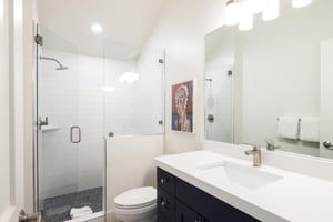 34 bathroom in the den with tiled shower and glass door