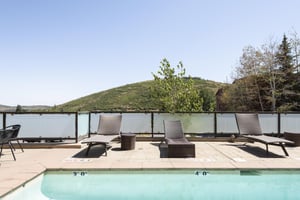 Poolside relaxation with lounge chairs and side tables