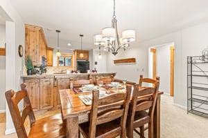 Snow Flower Condominium 14s dining area with seating for 5 and an open concept kitchen.