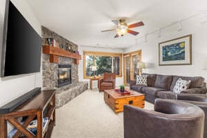 Snow Flower Condominium 14s open living room with flat screen TV and scenic views.