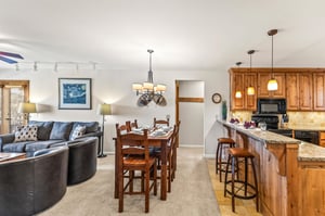 Snow Flower Condominium 14s dining room for 6 alongside additional counter seating for 2.