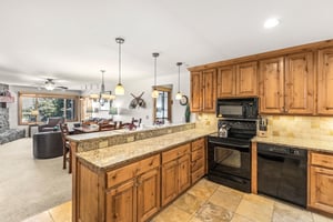 Snow Flower Condominium 14s granite countertops in open concept kitchen.