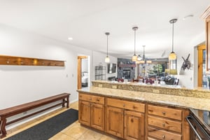 Snow Flower Condominium 14s granite counters with wood cabinets, as well as several power outlets for convenience.