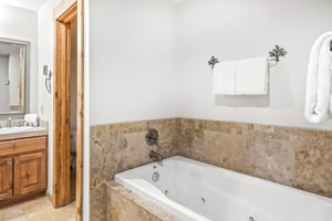 Snow Flower Condominium 14s main suites private bathroom with jetted tub.