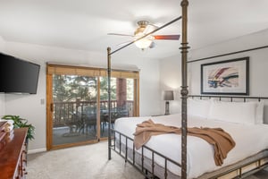 Snow Flower Condominium 14s main suite with king bed and access to private patio.